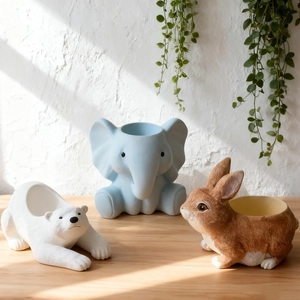 Detailed close-up of rabbit, polar bear and elephant shaped silicone succulent planters