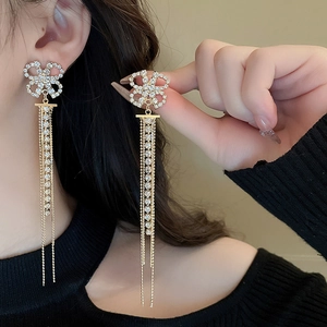 Golden fan-shaped tassel pearl earrings with rhinestones shown on model for women