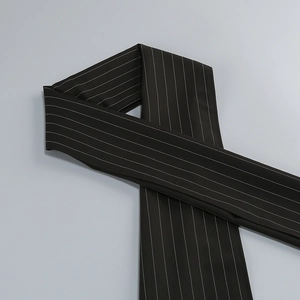 Close-up of black fabric with white pinstripes showing textile texture and elegant detail