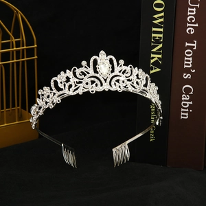 Detailed close-up of a silver bridal crown with sparkling rhinestones and securing combs