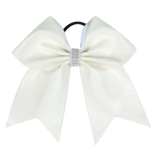 Close-up of white glitter cheerleader hair bow with sparkling rhinestone center and elastic band