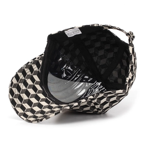 Detail view of the black interior lining and care label of a 3D geometric baseball cap