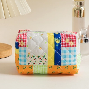 Close-up of a colorful quilted patchwork cosmetic bag with vibrant floral patterns.