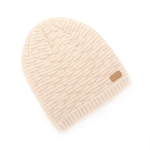 Macro view of cream knit beanie featuring basket weave texture and brown leather logo patch