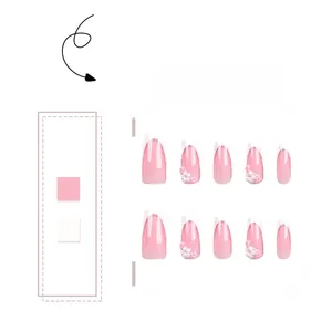 Detail of pink gradient press-on nails with white French tips and 3D floral accents