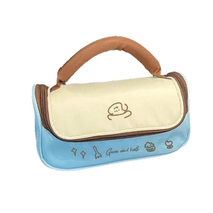 Large blue and cream makeup bag with cute dog pattern and sturdy brown carry handles