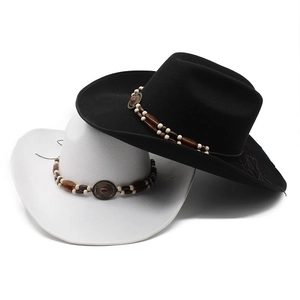 Detail of felt cowboy hats with vintage beaded bands and rustic stone ornaments