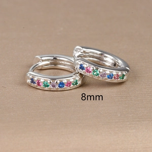 Detail shot of 8mm silver hoop earrings featuring multi-color gemstones on gold background
