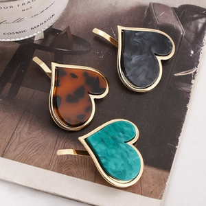 Japanese style heart hair clips in marble and tortoiseshell patterns with metal frames