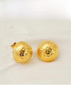 Detailed view of 18K gold plated stainless steel stud earrings with hammered texture