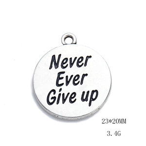 Detailed view of silver charm pendant with Never Ever Give Up quote and 23x20mm size info