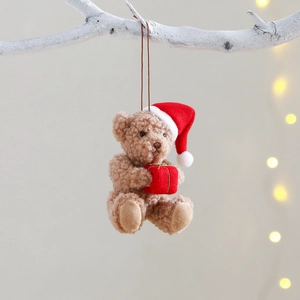 Christmas plush brown bear with red hat and gift box hanging on white branch decor