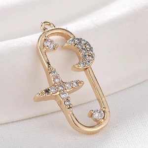 Star and moon gold plated pendant with micro-pave cubic zirconia on white silk