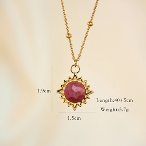 Macro detail of sun pendant with dimensions showing red gemstone and gold chain