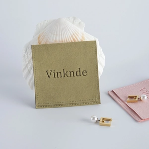Detail of elegant pearl geometric earrings and luxury microfiber velvet jewelry pouches