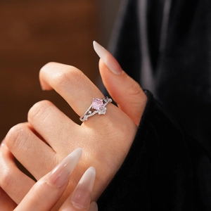 Macro shot of silver stackable crown ring featuring a sparkling round pink zircon stone