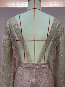 Detail showing the deep V backless design and sparkling sequins of this pink romper
