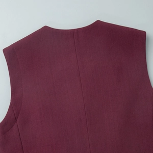 Close-up of burgundy vest back neckline showing high-density stitching and fabric texture