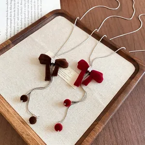 Elegant velvet bow pendant necklaces with zircon crystals in brown and burgundy shades