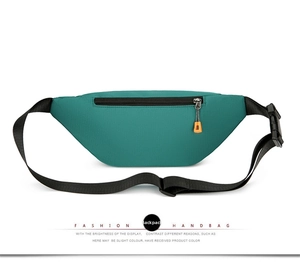 Detail view of the back side of the teal oxford fabric waist bag with zipper pocket