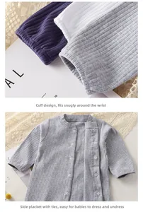 Detail of ribbed cotton baby romper sleeve and asymmetric snap button closure