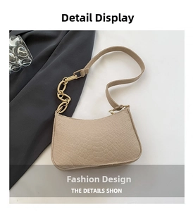 Detail of beige faux crocodile leather shoulder bag with gold chain strap stitching