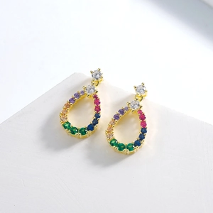 Elegant gold teardrop earrings with multi-colored cubic zirconia on a white display