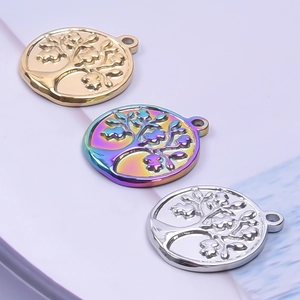 Detailed view of tree of life pendants in gold, silver, and iridescent finishes