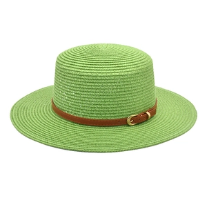 Detail of lime green boater hat featuring fine straw weave and brown leather belt buckle
