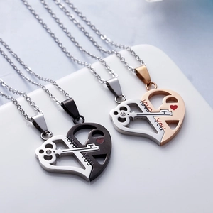 Close-up of heart and key puzzle necklaces with Love You engraving and crystal accents