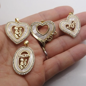 Golden heart necklace with MOM lettering and cubic zirconia shell pendant on a box chain