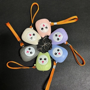 Detailed overhead view of six colorful cat-shaped personal alarms with orange lanyards