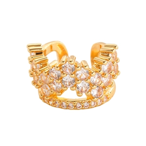 Detail of gold crown ear cuff with three layered rows of zircon stones on white backdrop