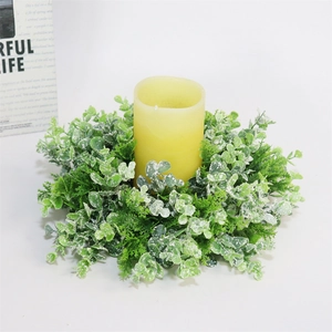 Artificial eucalyptus wreath with white frosting effect and yellow pillar candle center