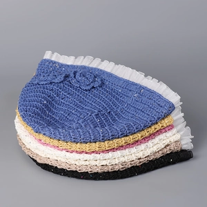 Detail of handmade crochet bucket hats with sequins, floral accent and mesh brim