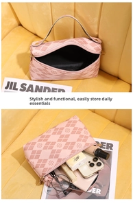 Detailed interior view of pink quilted clover tote bag holding phone and cosmetics
