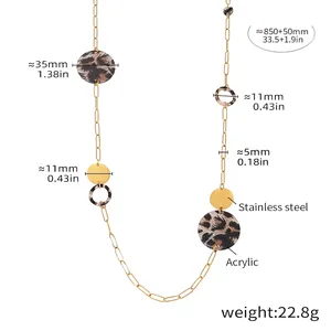 Macro detail of golden stainless steel chain with round acrylic leopard print discs