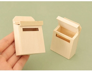 Miniature wooden dollhouse mailboxes shown with open and closed lids on green background