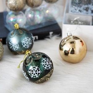Nordic Christmas balls with white snowflake patterns and gold glitter decor on green spheres