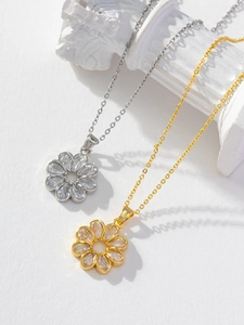 Detailed view of sunflower necklaces with sparkling zircon in gold and silver finish