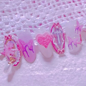 Pink and purple Y2K handmade press-on nails with 3D hearts, pearls, and butterfly charms