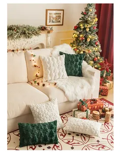 Close-up of Christmas pillows with embroidered trees and snowflakes on a cozy sofa