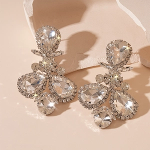 Detailed macro view of luxury teardrop crystal earrings with silver-toned settings