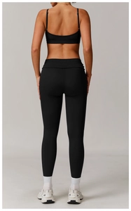 Detail view of the back of a black yoga set with racerback bra and high-waist leggings