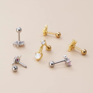 Detail of pink zircon heart and butterfly cartilage earrings with screw flat backs
