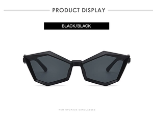 Close-up of black geometric polygon sunglasses showing sharp frame lines and high-end texture