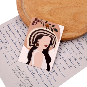 Flat minimalist jewelry card with female illustration on a rustic wooden tray setup