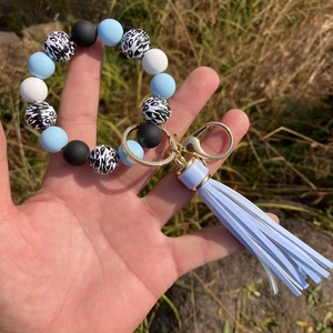 Beaded silicone keychain bracelet with leopard print beads and light blue tassel