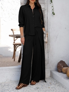 Elegant black two-piece set featuring long sleeve button shirt and side slit wide-leg pants
