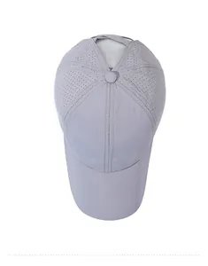 Top view of grey ponytail baseball cap with laser-cut ventilation holes for breathability